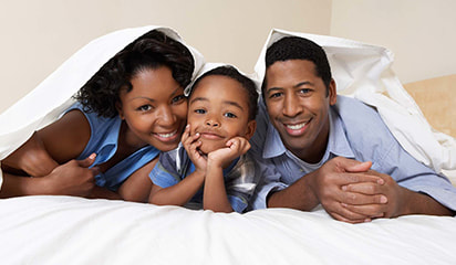 African american family enjoying the bed